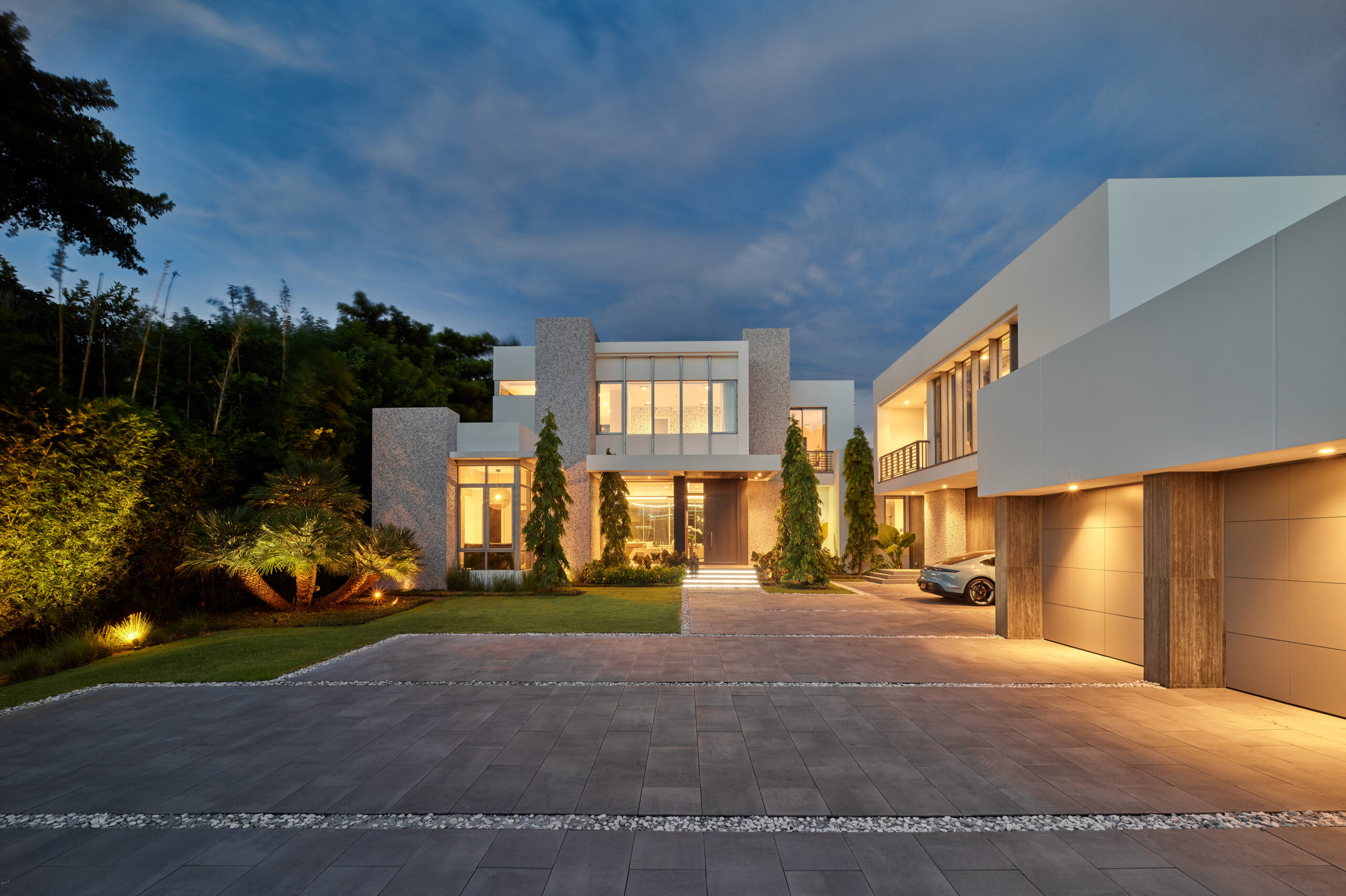 Modern luxury South Florida residence illuminated at dusk
