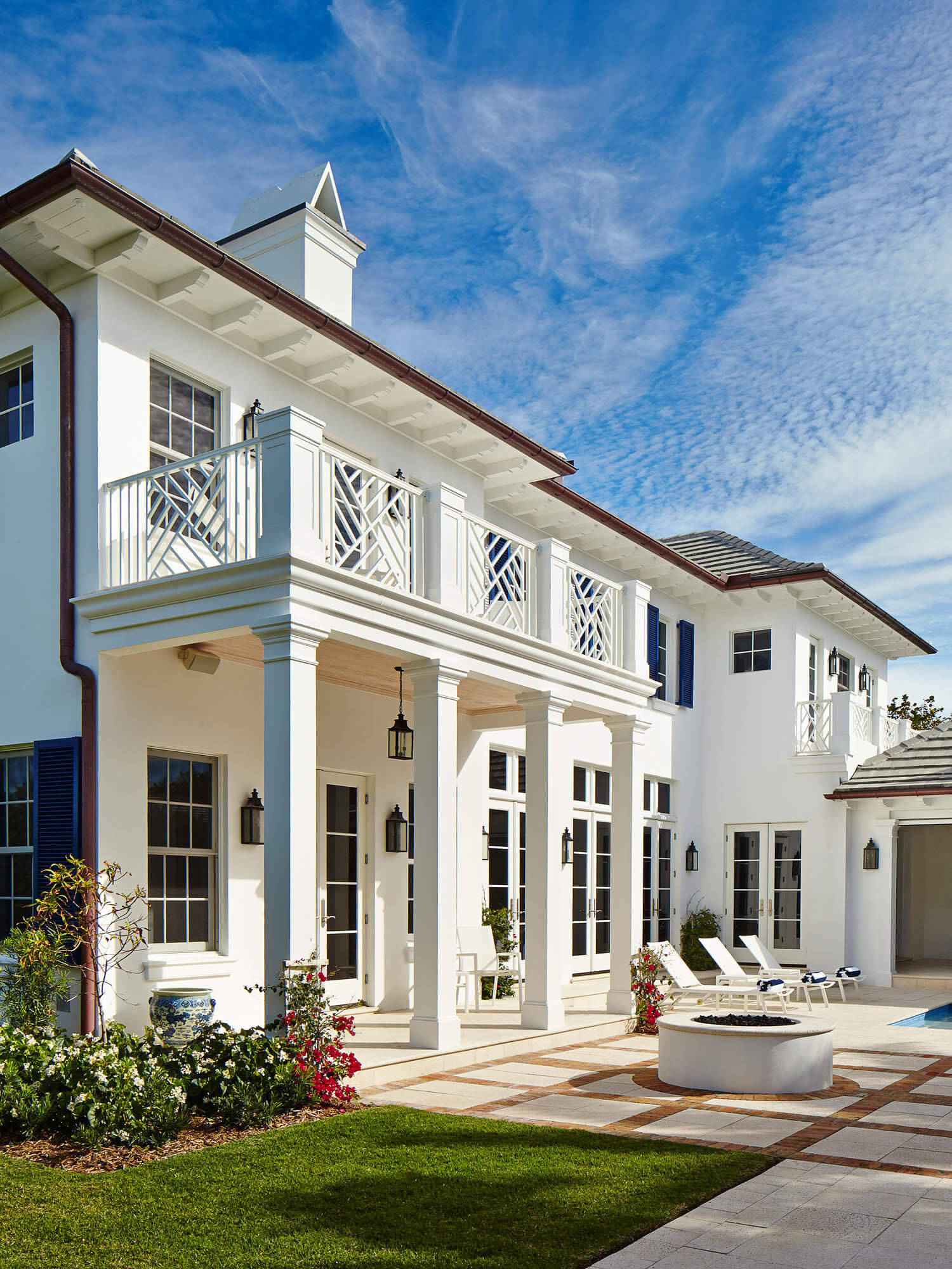 White colonial-style residence with detailed balcony railings