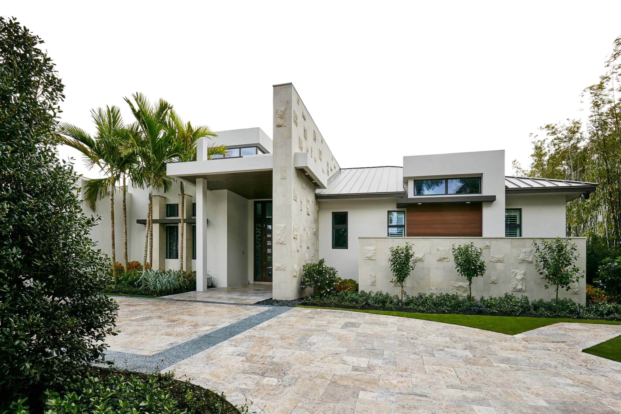 Contemporary single-story luxury home framed by palm trees