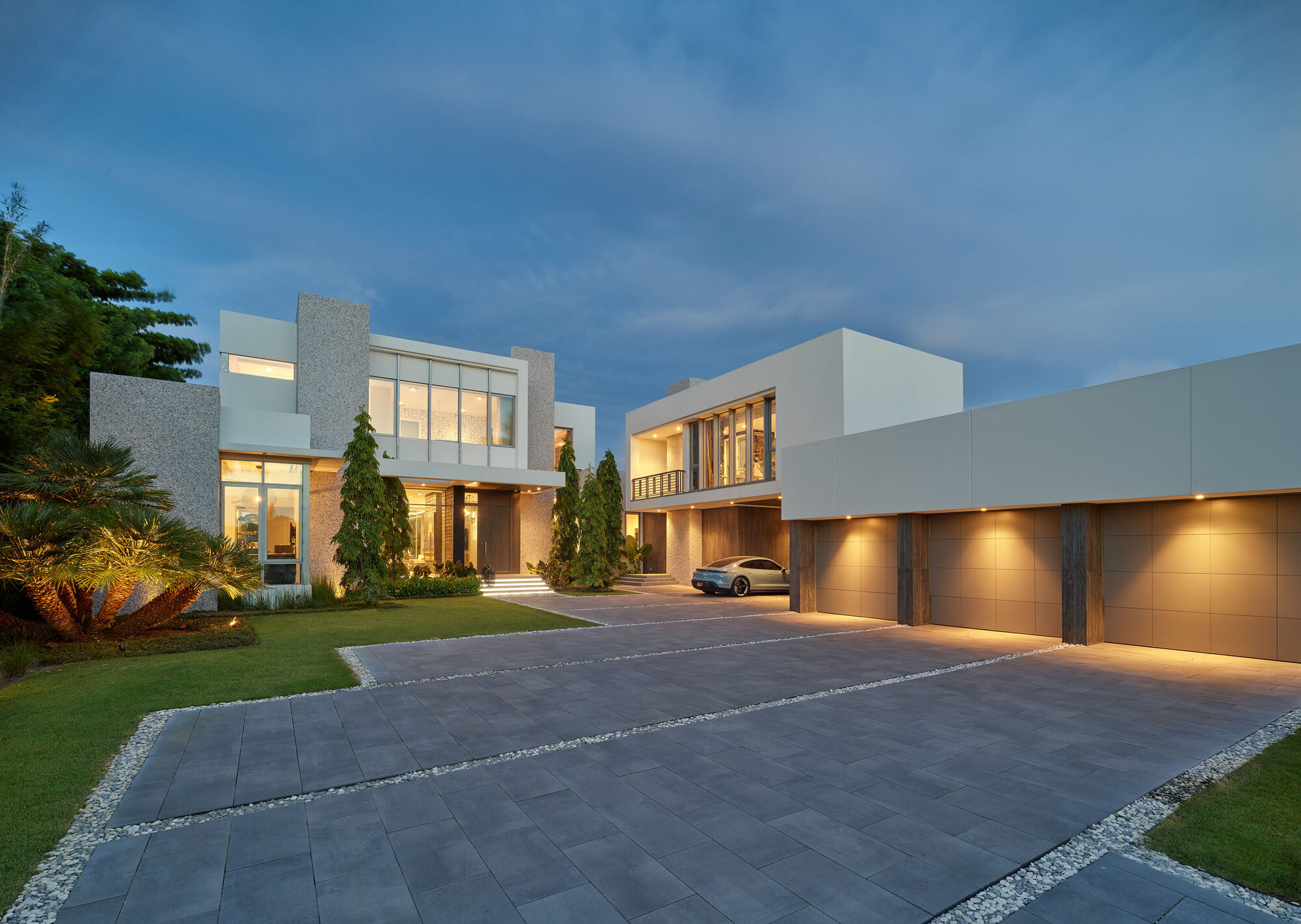 Modern luxury South Florida residence illuminated at dusk