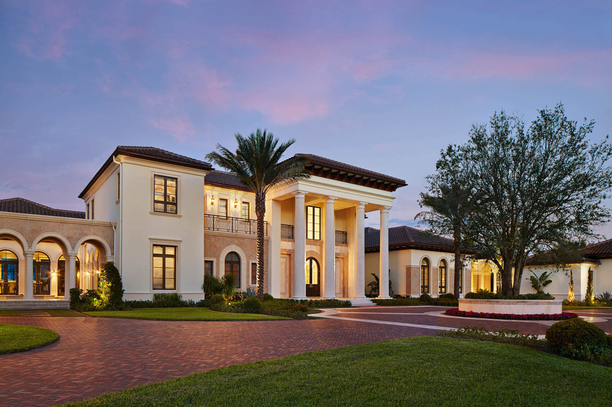 White luxury estate with a resort-style pool and landscaped grounds
